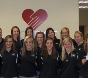 Frazee girls volleyball team. Far R Katie Smith presents check to Joy Crouch HRRV